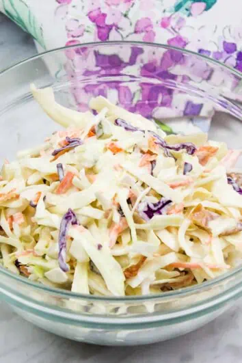 pickle slaw with bacon in a glass bowl