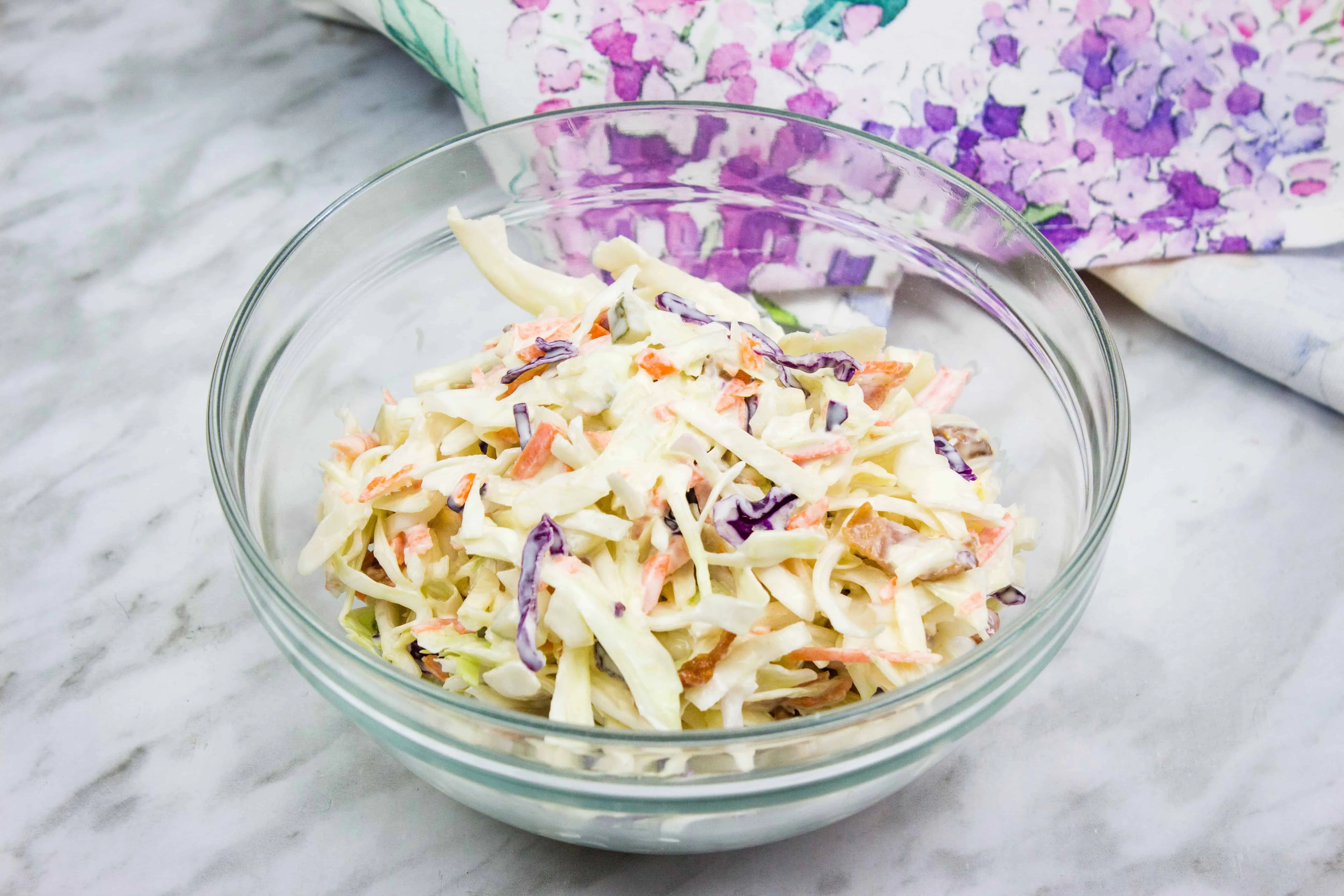 pickle slaw with bacon in a glass bowl