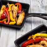 two portions of air fryer fajitas on square cast iron plates