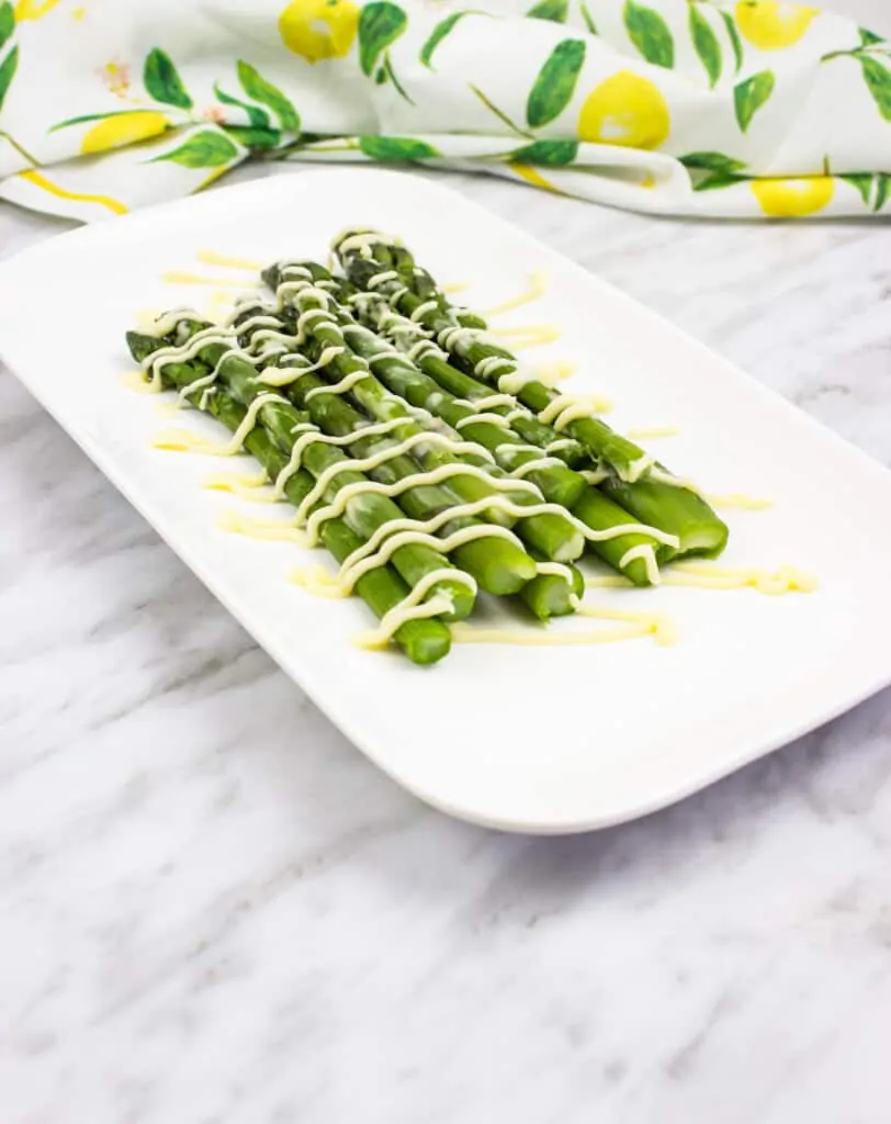 easy keto asparagus with lemon on a white plate