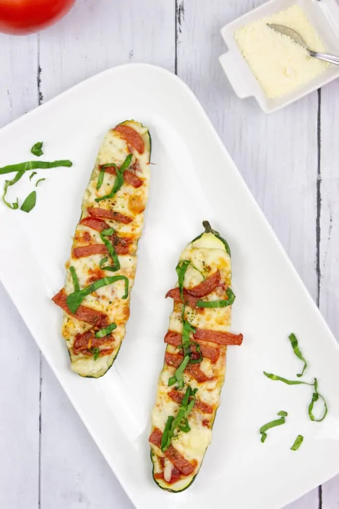 Two zucchini pizza boats on a plate