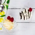 two scoops of keto ice cream, one topped with caramel sauce, the other topped with chocolate sauce