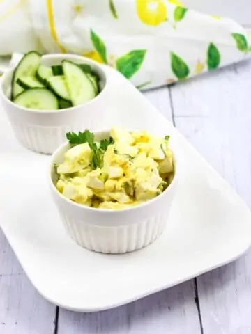 The Best Keto Egg Salad recipe on a plate with cucumbers