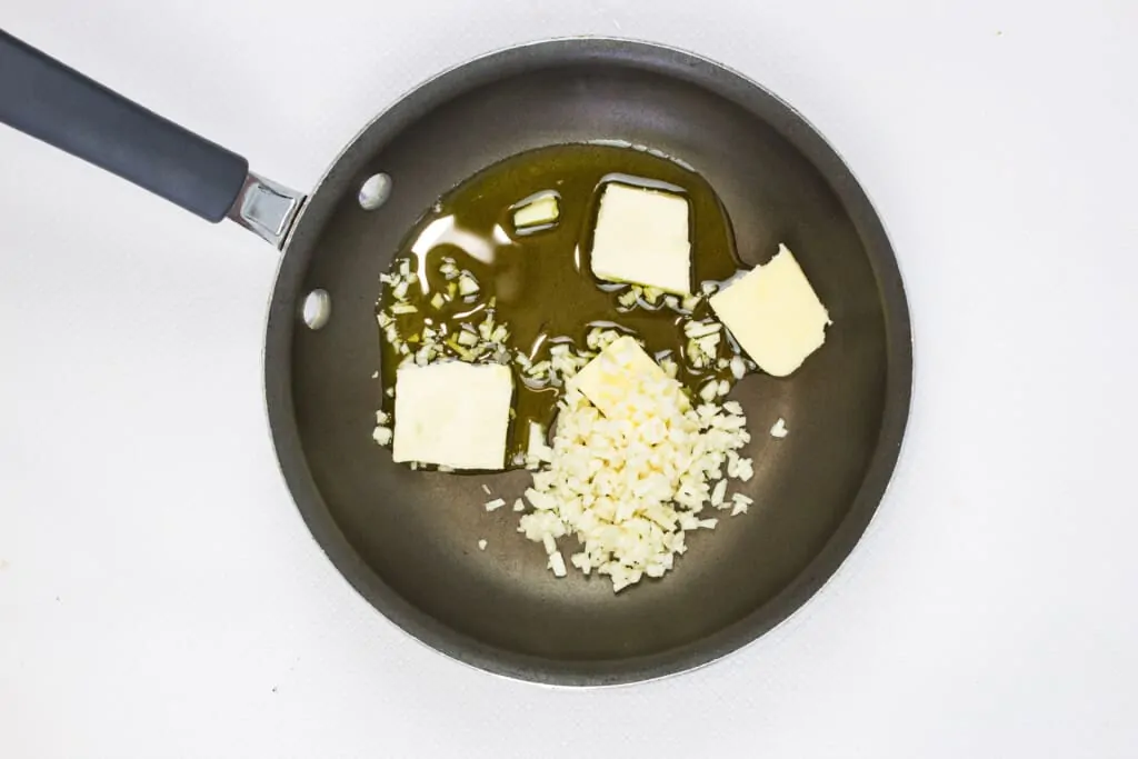 melting the butter and cooking the garlic in a skillet
