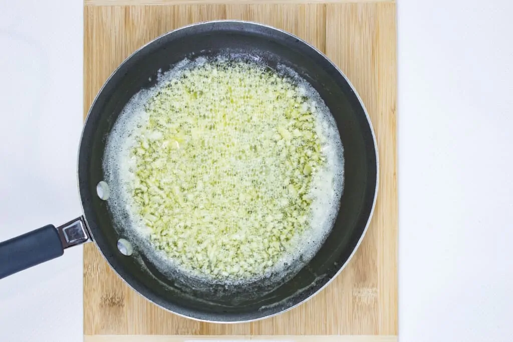 cooking the garlic in a skillet for 1-2 minutes