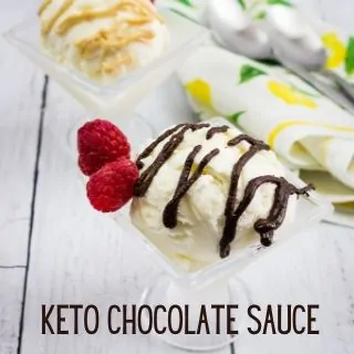 keto chocolate sauce drizzled over ice cream with raspberries on the side