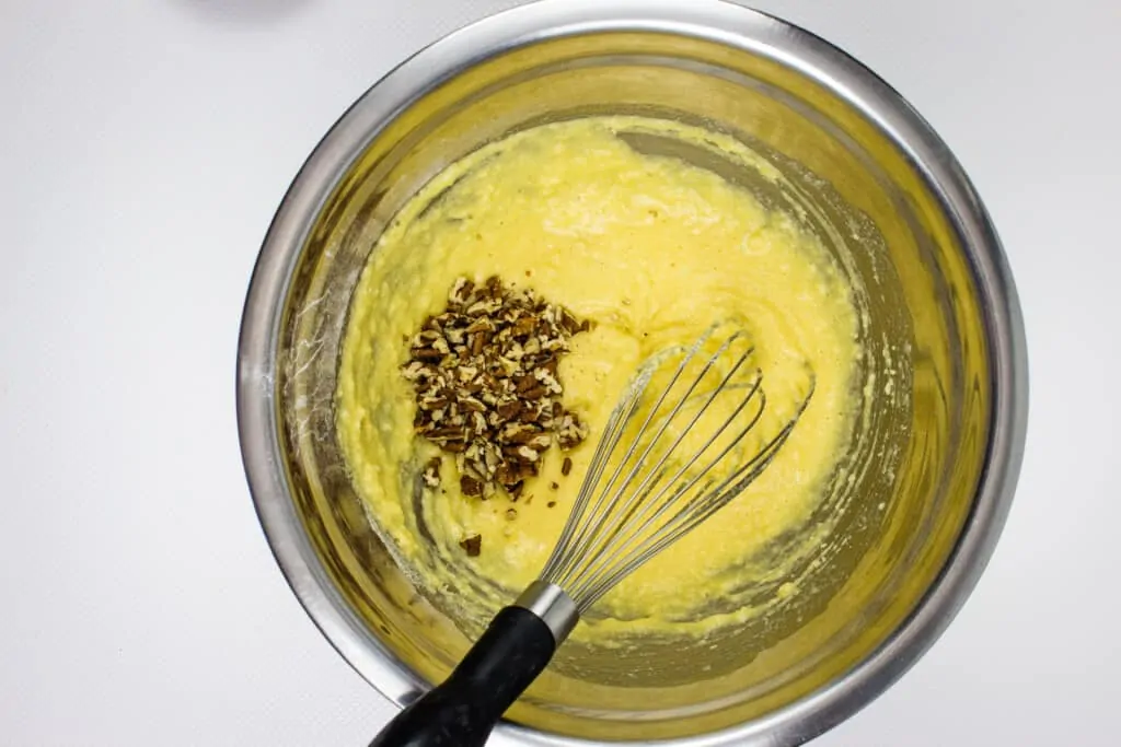 adding the pecans to the batter