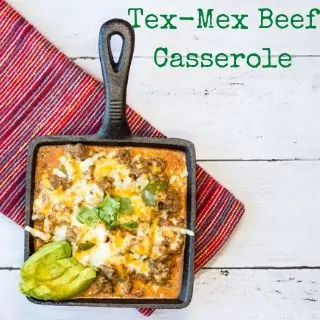 Tex-Mex Beef Casserole on a square black iron skillet with a garnish of sliced avocado.