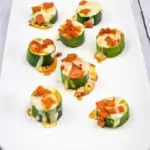 zucchini pizza bites on a rectangular white platter