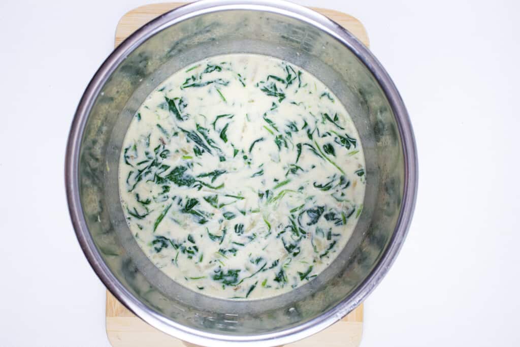 reduce the cream and broth then add the spinach, parmesan and dijon mustard