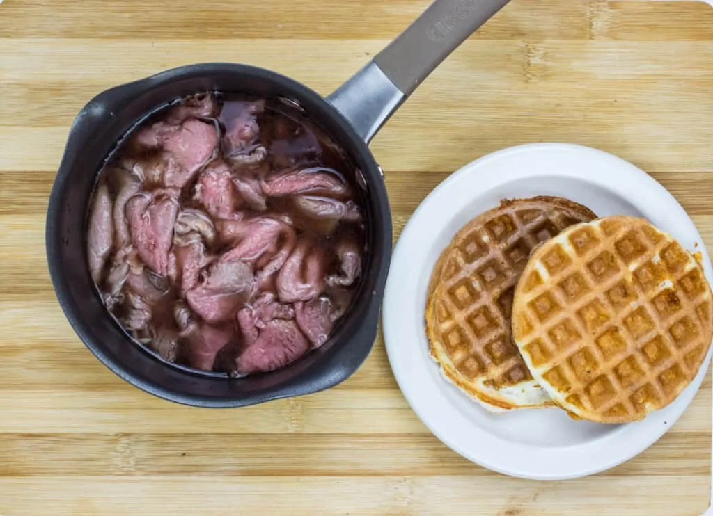 sliced beef warming in the beef broth