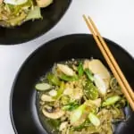 keto chicken stir fry in two black bowls with chopsticks