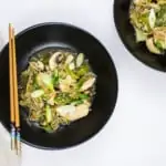 two servings of keto chicken stir fry on black plates