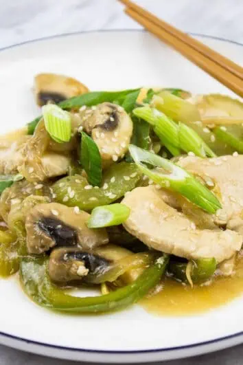 keto chicken stir fry on a plate with chopsticks on the side