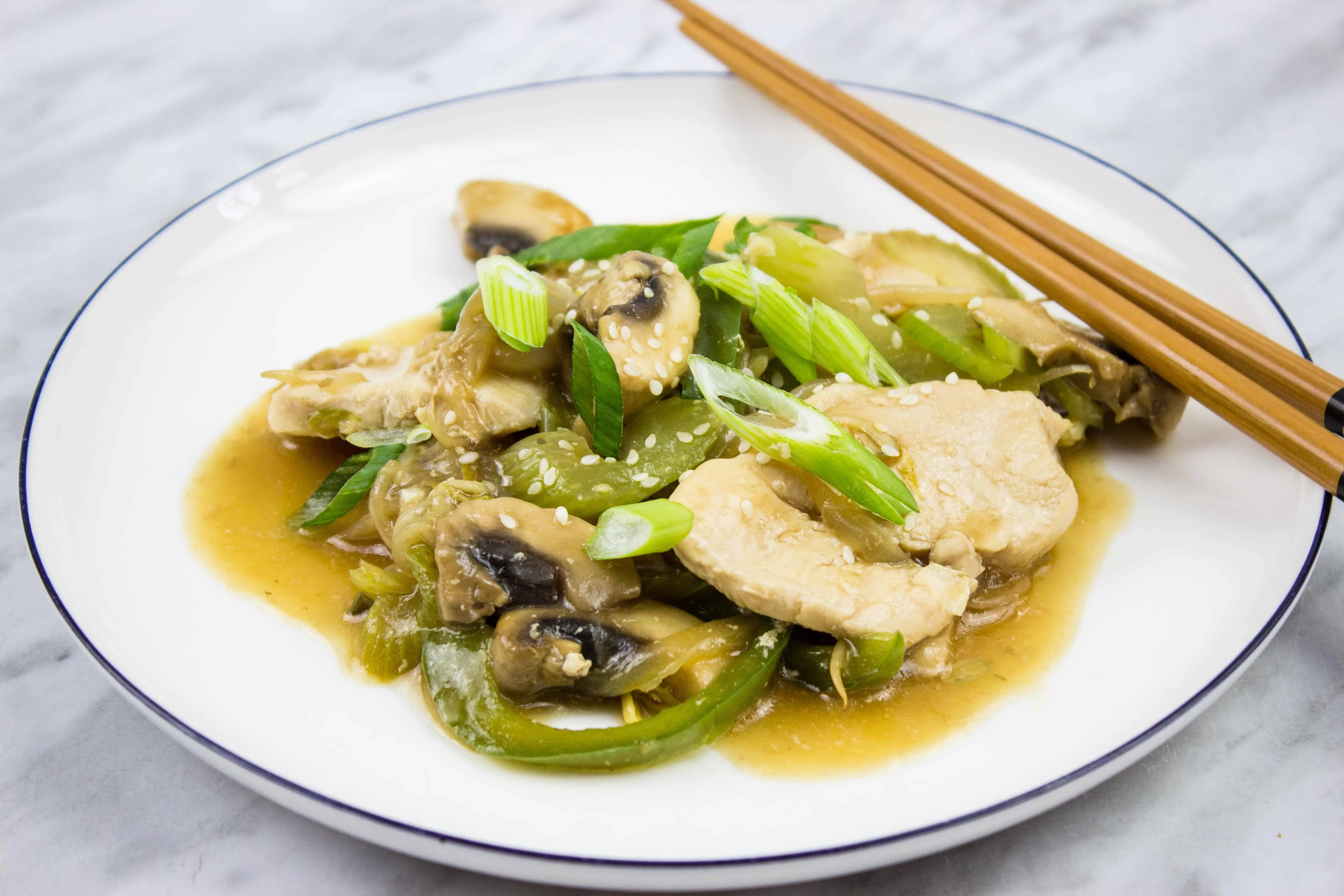 keto chicken stir fry on a plate with chopsticks on the side