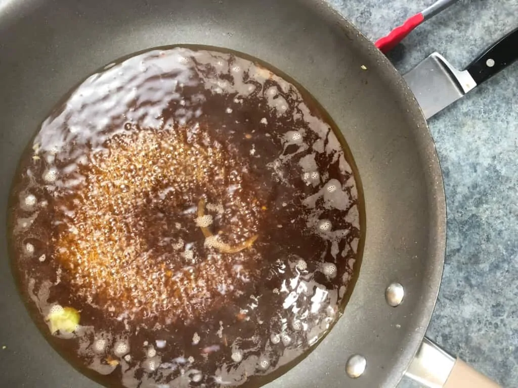 reducing the sauce for the keto chicken stir fry