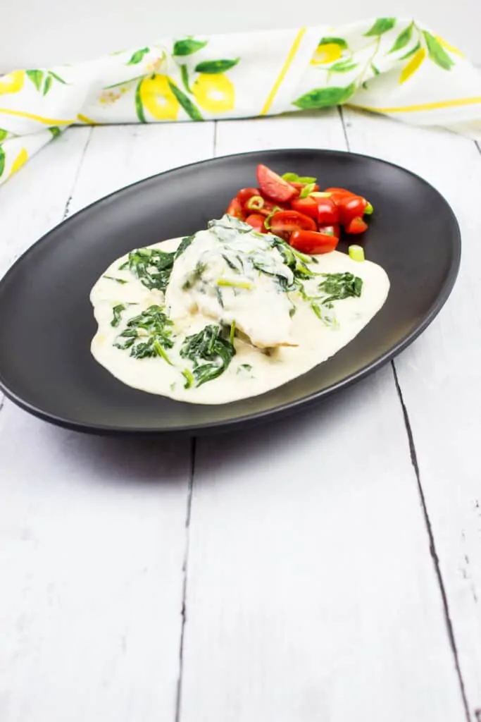 instant pot keto chicken florentine on a black oval plate