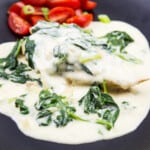 keto chicken florentine on an oval black plate