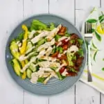 keto cobb salad in a gray bowl with a napkin and fork on the side