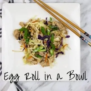 egg roll in a bowl on a plate with chopsticks