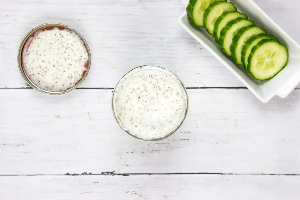 top-down picture of creamy keto ranch dressing with cucumbers