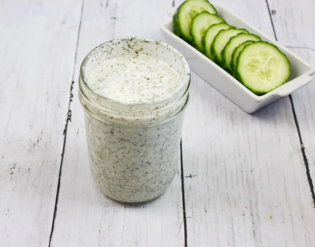 ranch dressing in a jar with cucumbers in the background, for keto cobb salad