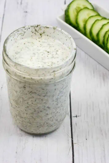 ranch dressing in a jar with cucumbers in the background, for keto cobb salad