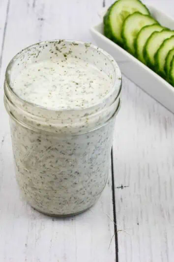 Ranch Dressing in a jar with cucumbers in the background, for keto cobb salad