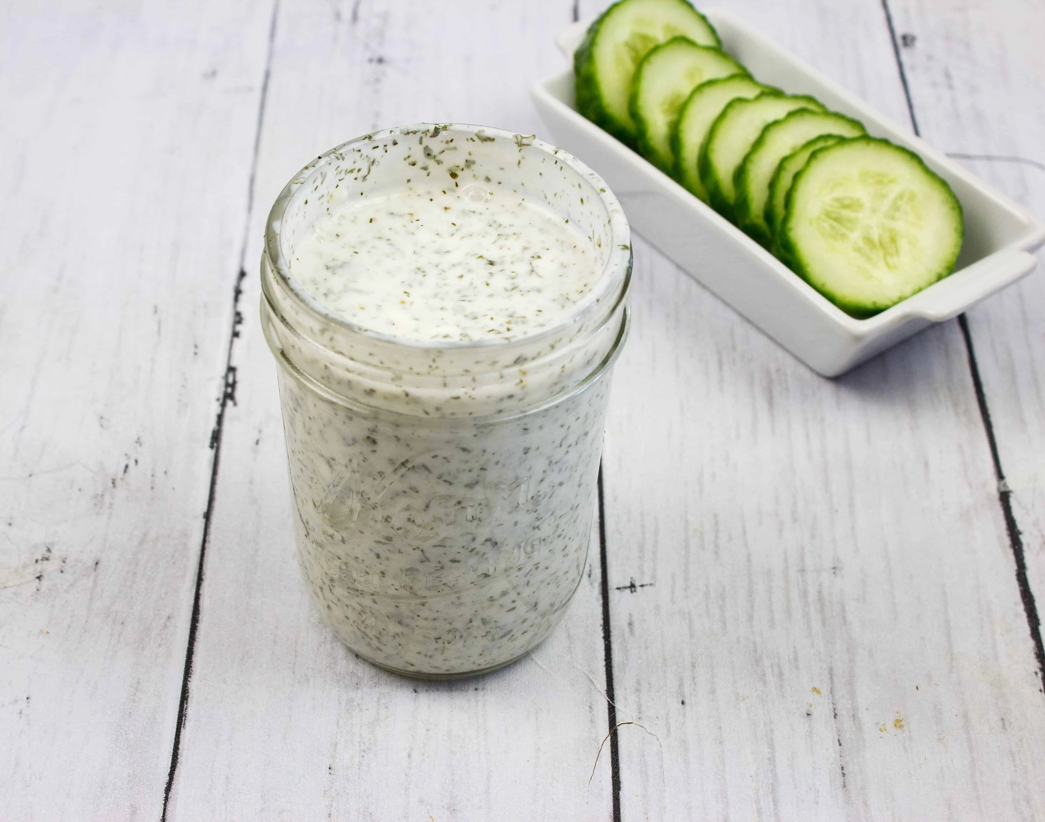 Ranch Dressing in a jar with cucumbers in the background, for keto cobb salad