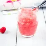 frozen raspberry vodka slush in glasses with tiny spoons