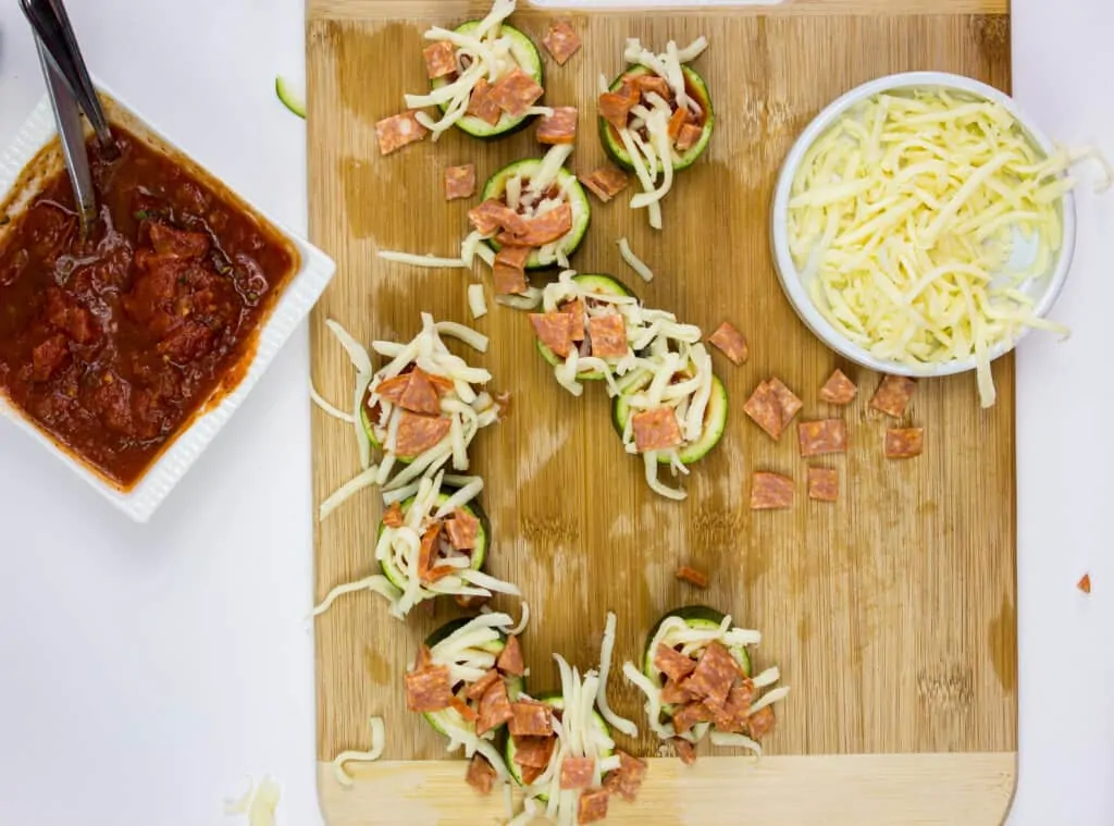 top each zucchini bite with cheese and your favorite toppings