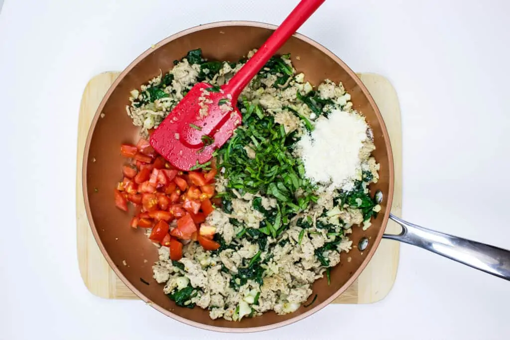 add the tomato and parmesan to the skillet