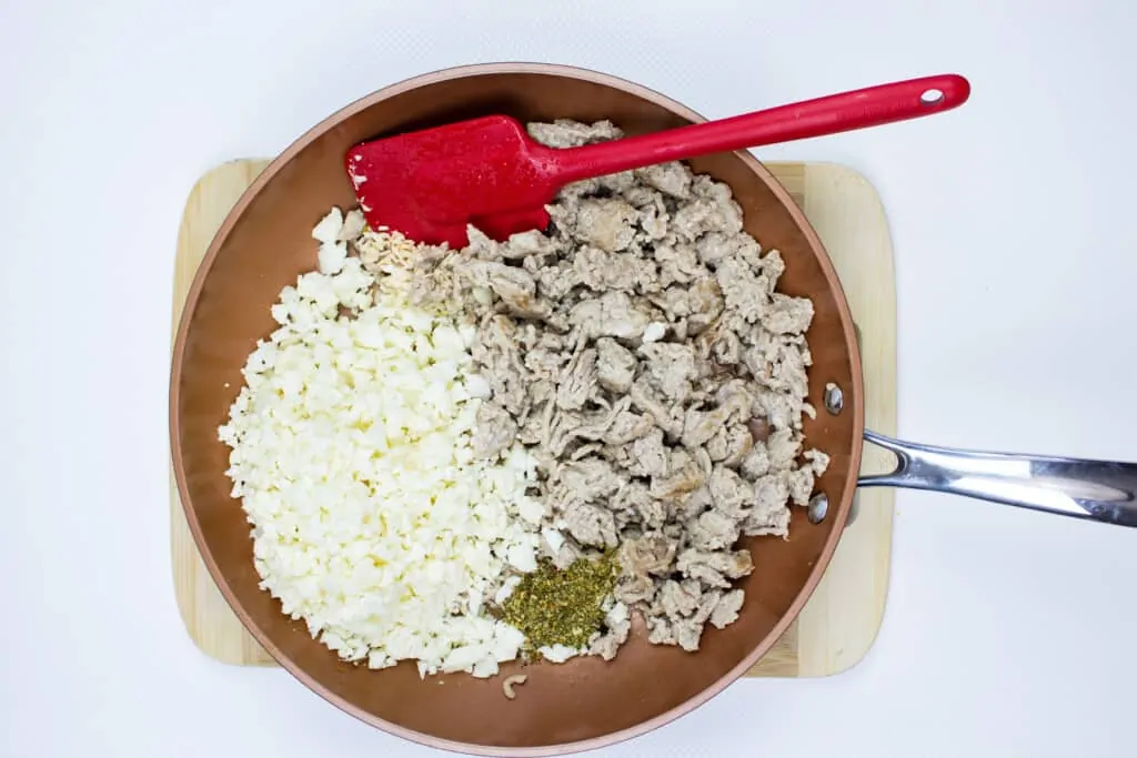 add the riced cauliflower to the browned meat