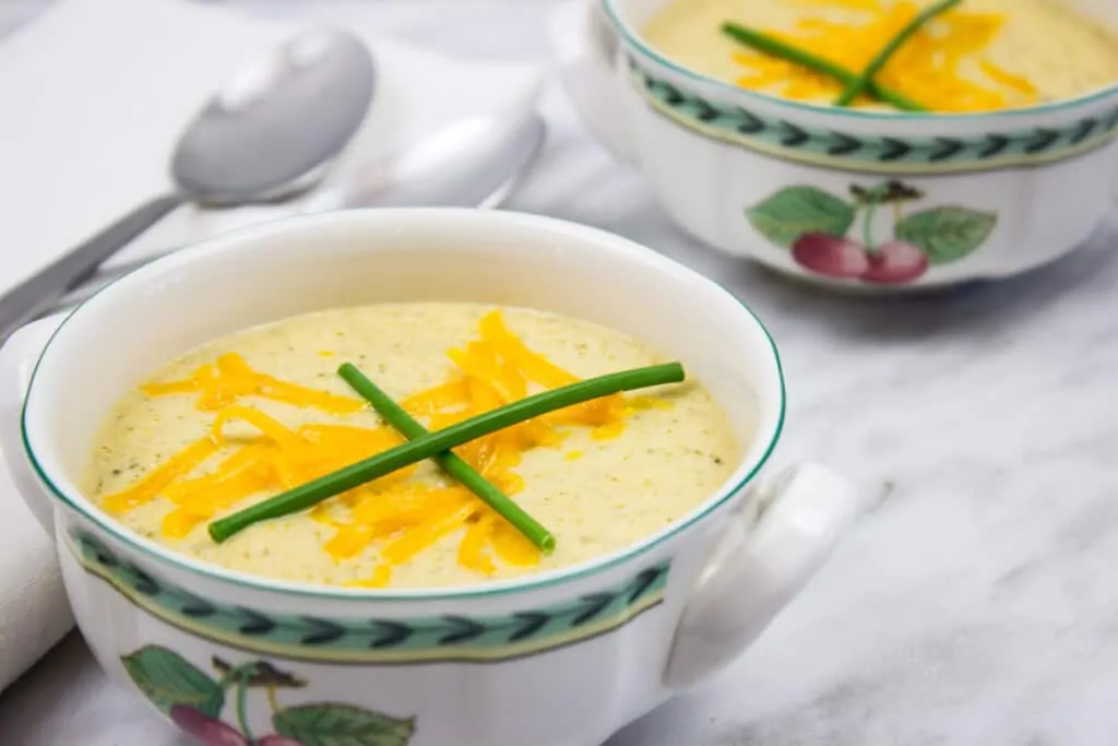 keto broccoli cheese soup in two bowls with spoons