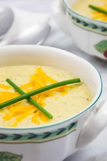 keto broccoli cheese soup in two bowls with spoons