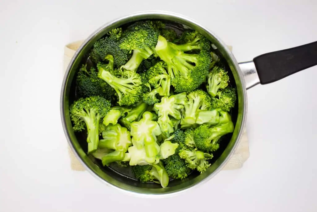 add the broccoli and broth and simmer to make keto broccoli cheese soup