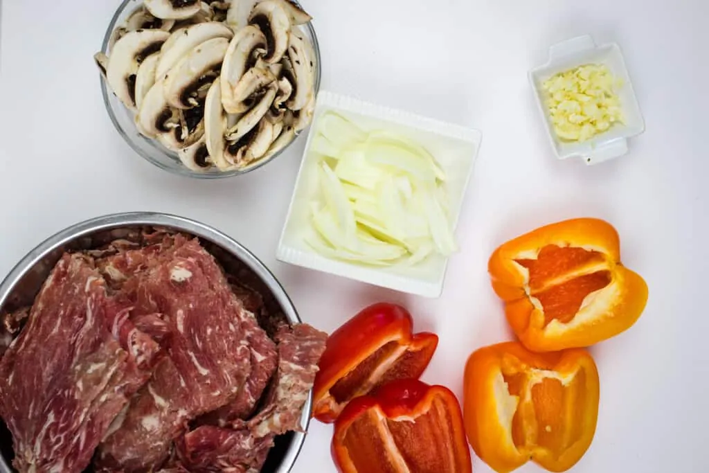 prepped ingredients to make keto philly cheesesteak stuffed peppers