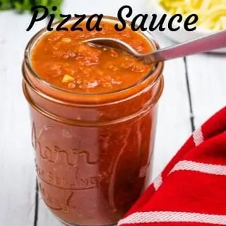 keto pizza sauce in a jar with a spoon