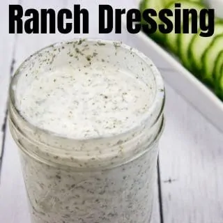 ranch dressing in a jar with cucumbers in background