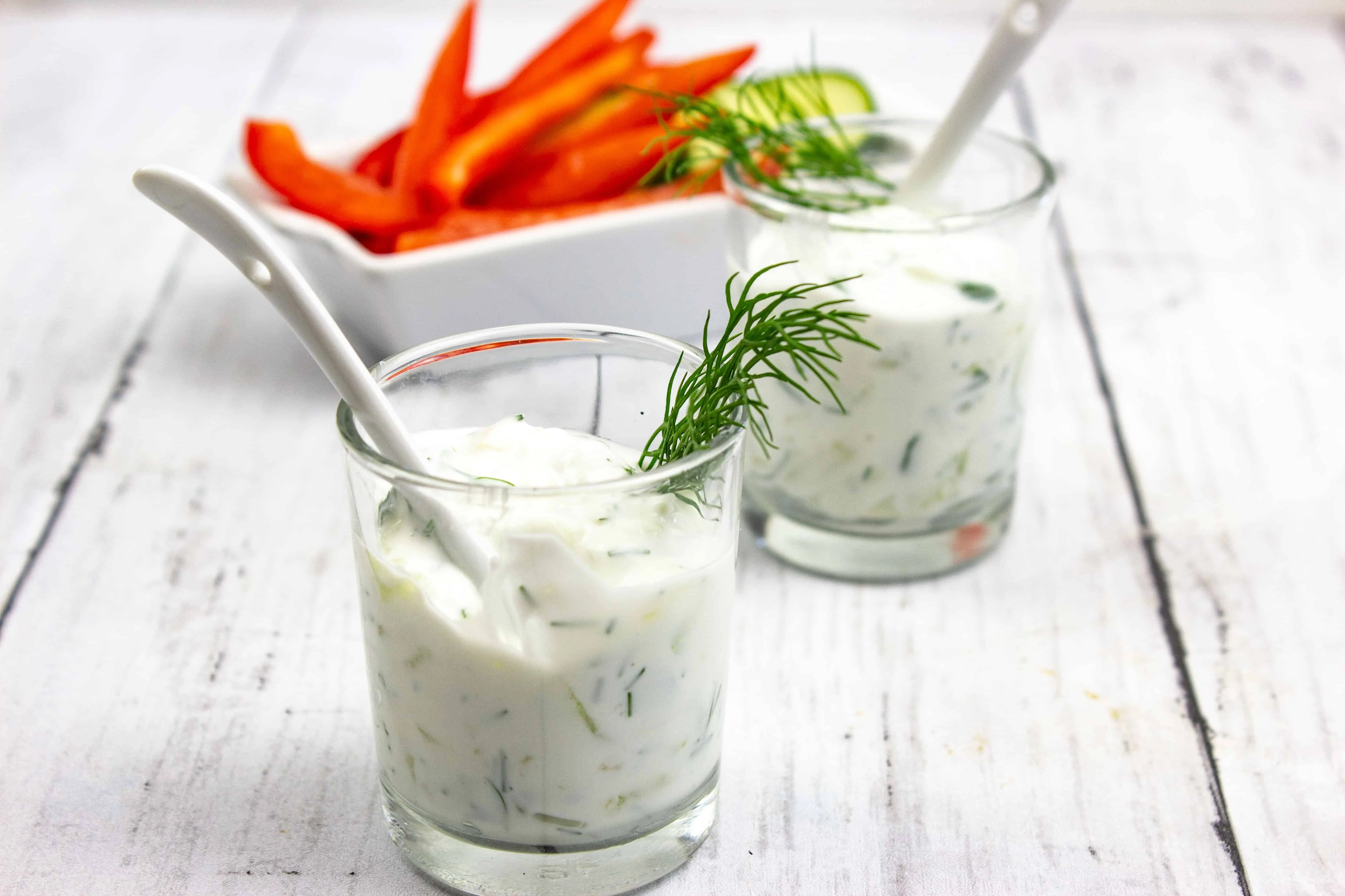 tzatziki sauce keto in glass dishes with veggies in the back