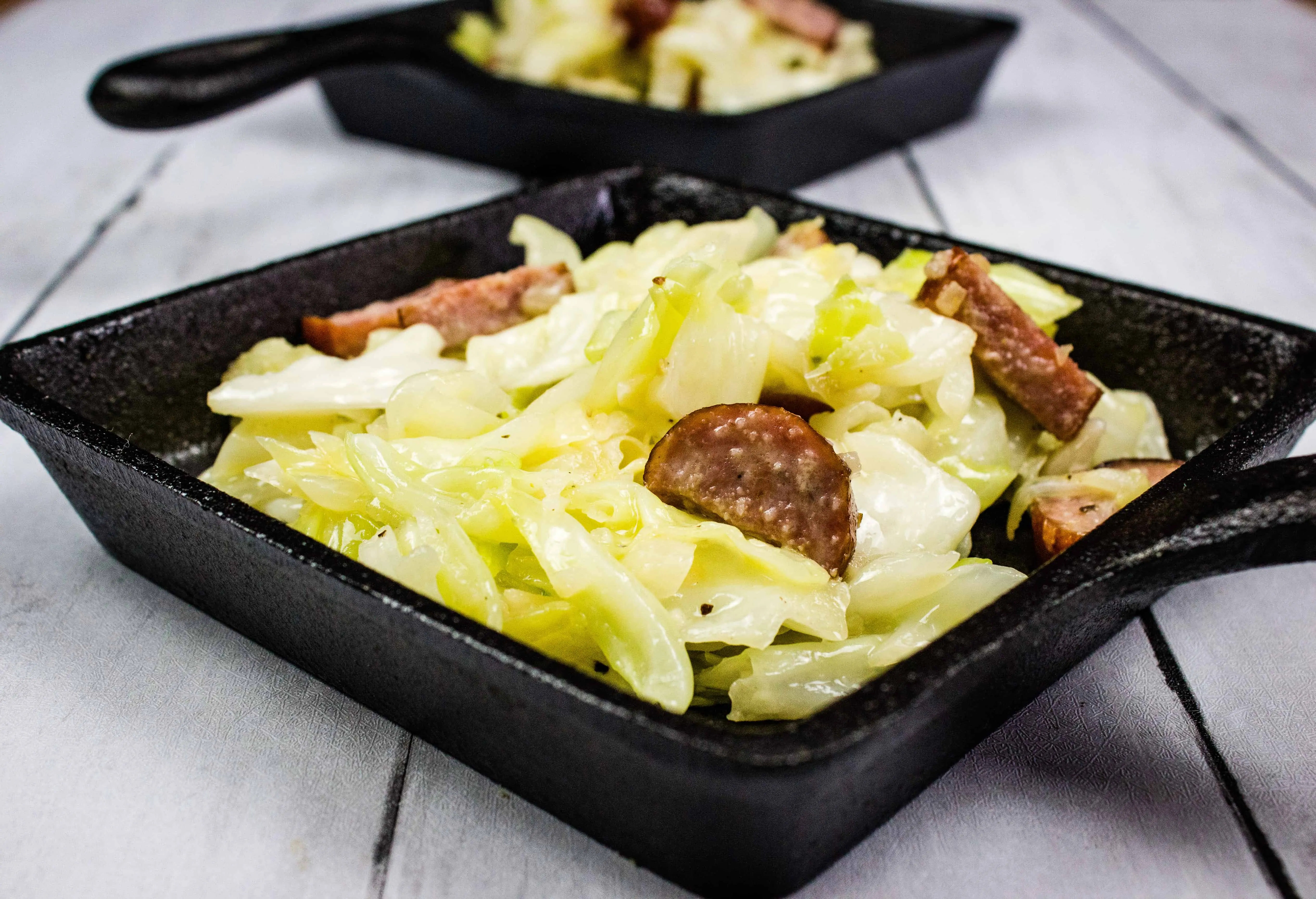 keto cabbage and sausage side dish in a square skillet