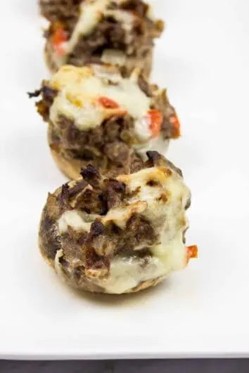 keto philly cheesesteak stuffed mushroom caps on a serving plate
