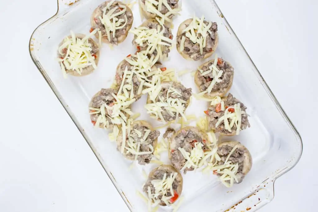 top the keto philly cheesesteak stuffed mushroom caps with cheese