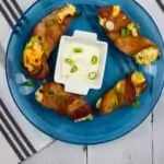 ranch keto jalapeno poppers on a blue plate with sauce
