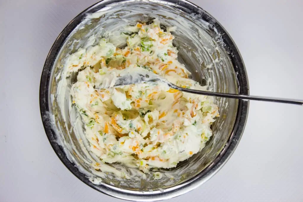 mix ranch powder, cheeses, and spices in a bowl