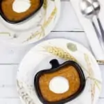 ketp pumpkin custard in a ramekin on a plate with spoons