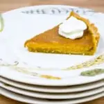slice of keto pumpkin pie on a stack of plates