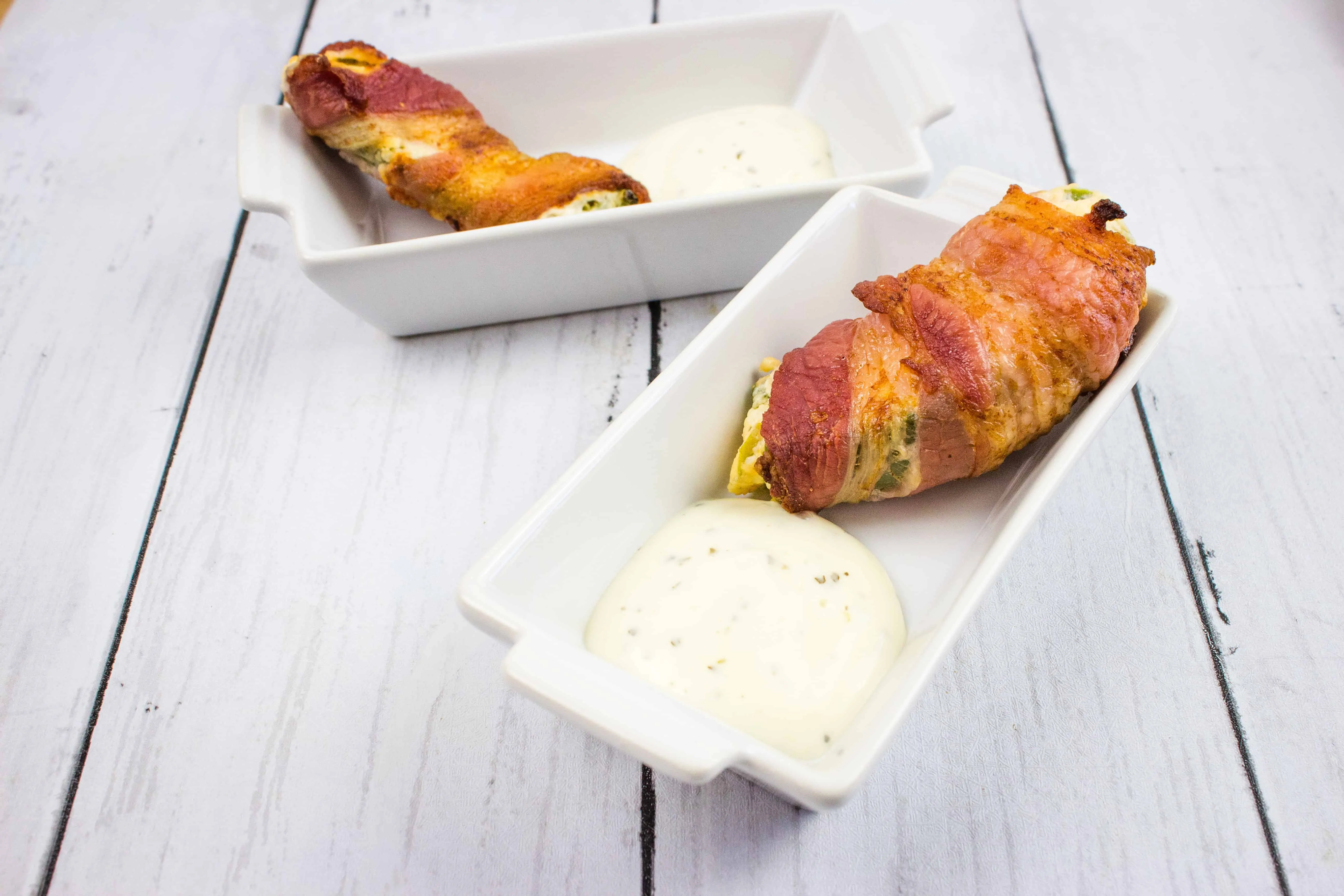 ranch keto jalapeno poppers on a serving dish with sauce