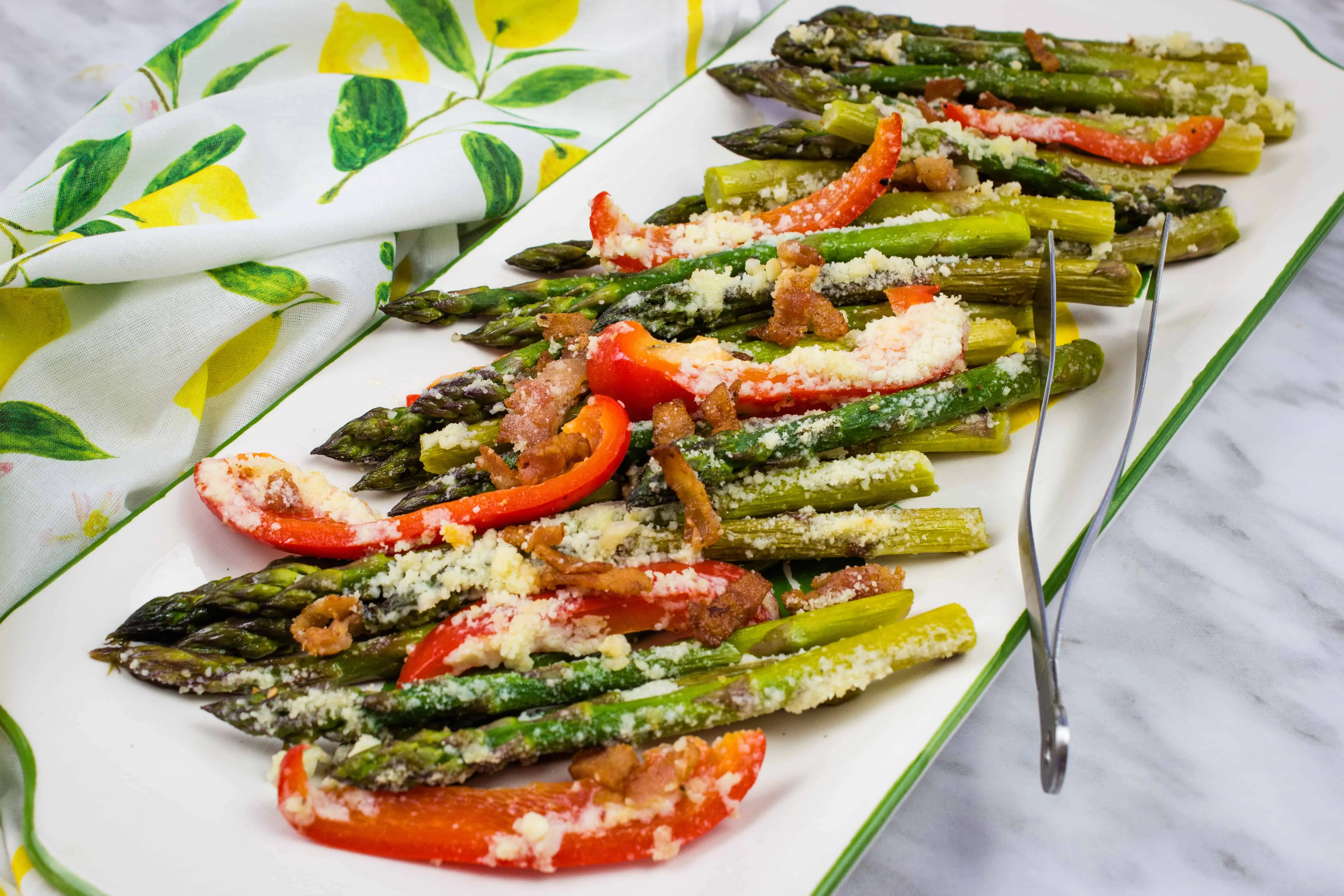 keto cheesy baked asparagus with bacon and bell peppers on a platter