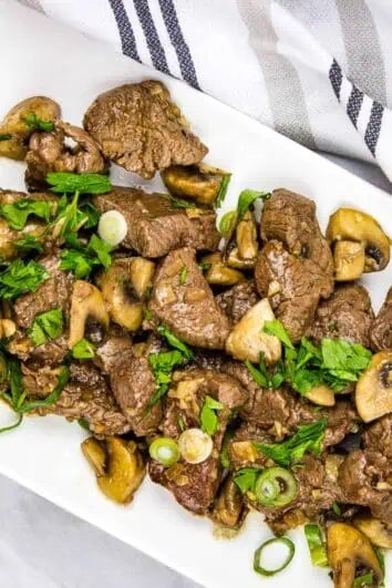 keto Garlic steak & mushrooms on a rectangular platter